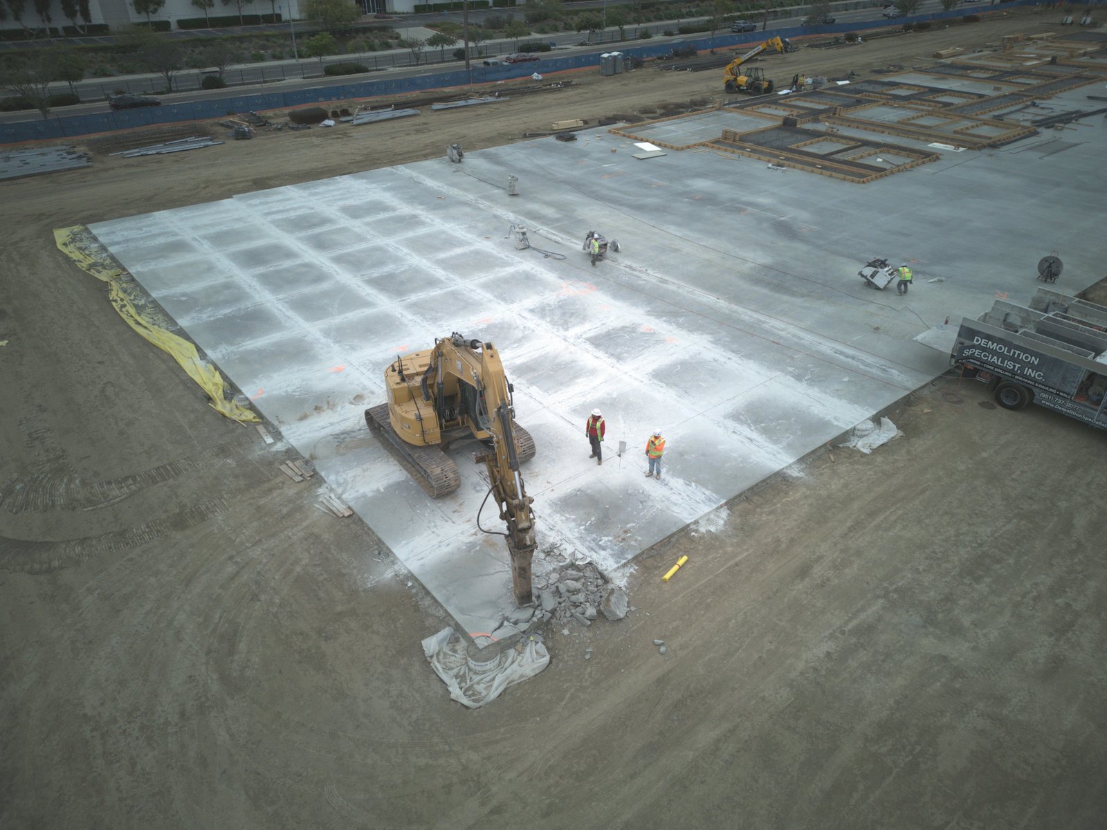Aerial view of hydraulic breaker demolishing concrete panels